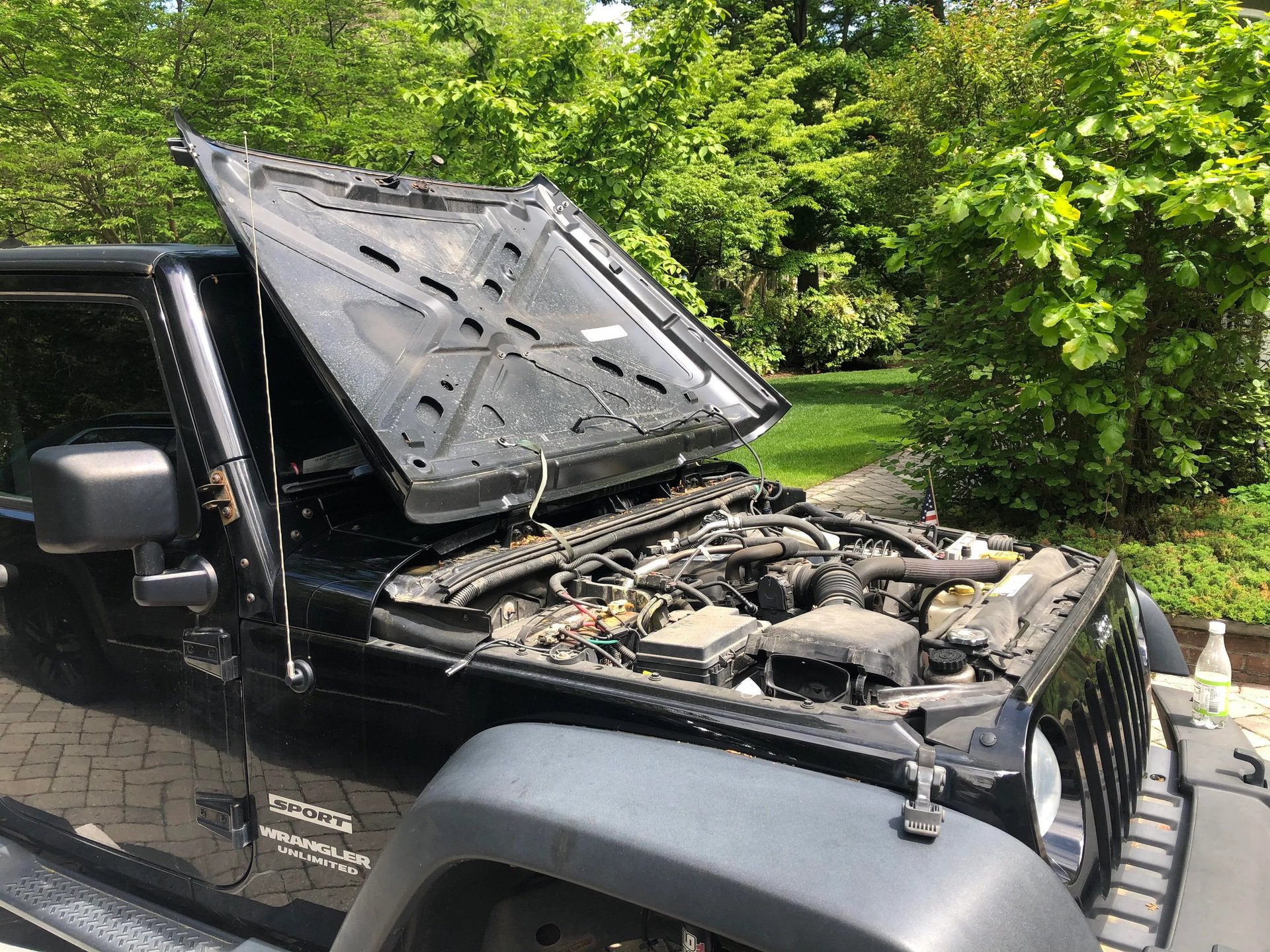 JK black Jeep Wrangler with hood open