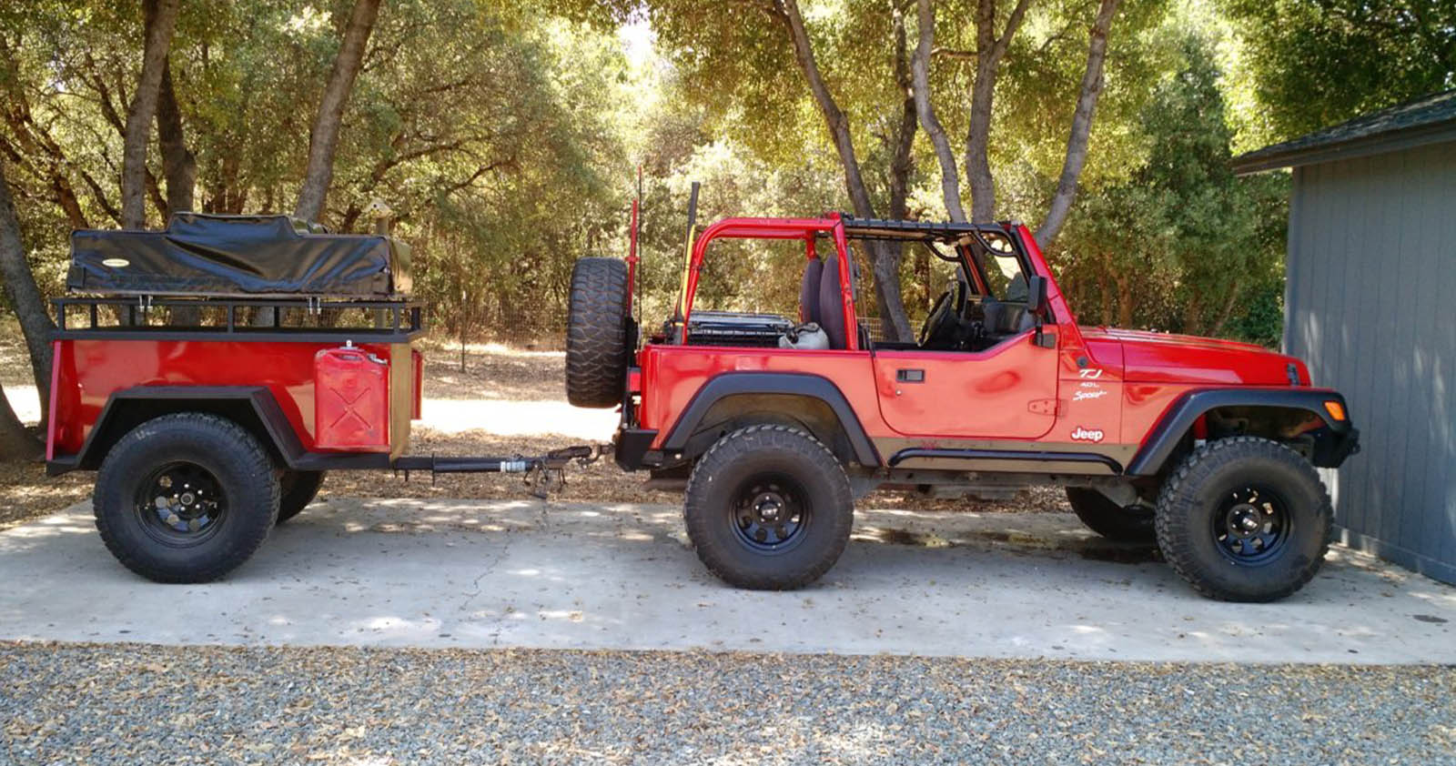 Red Jeep towing a trailer