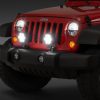 Bright LED headlights on a red Jeep Wrangler
