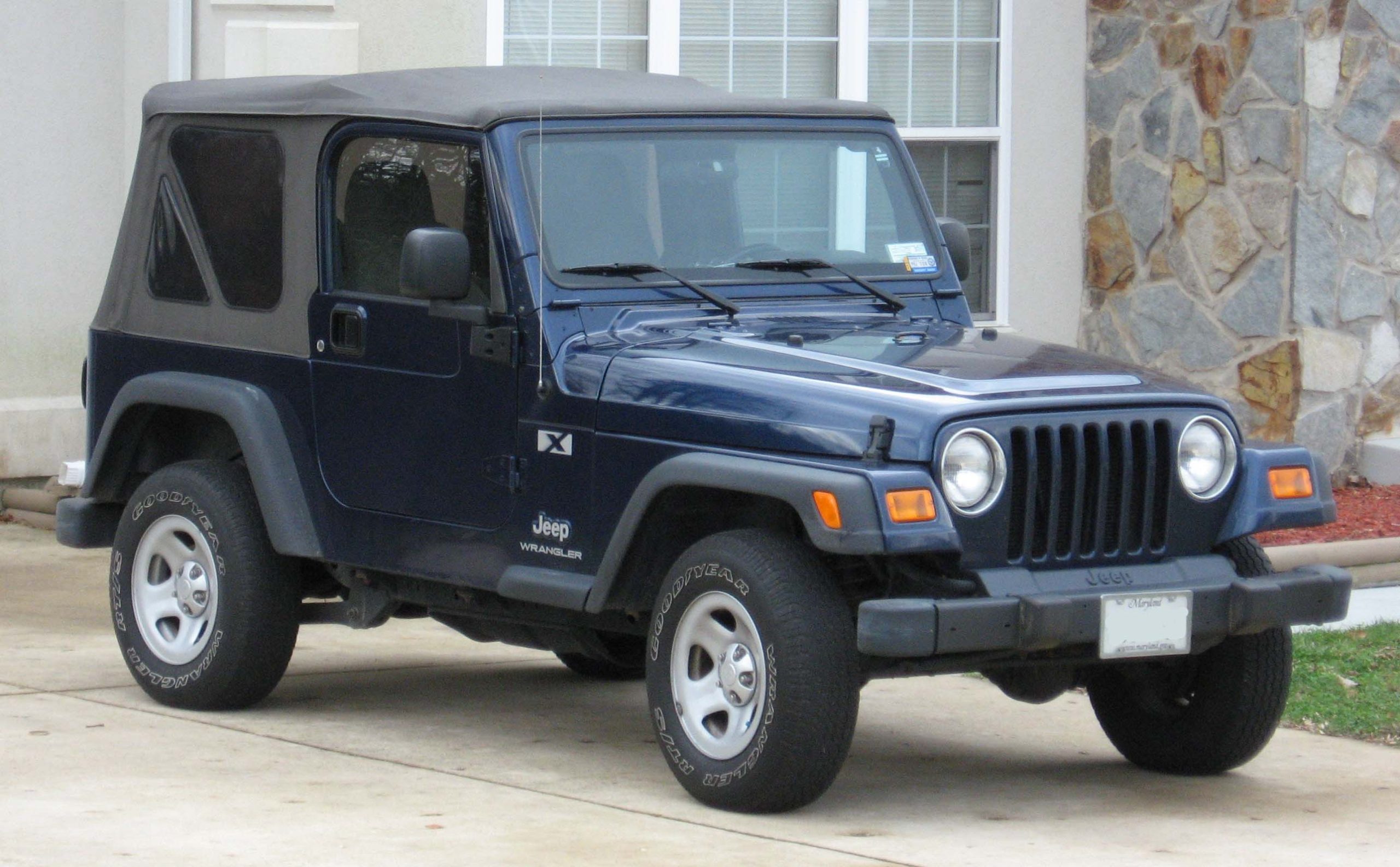 Three-quarter side view of a blue TJ Jeep Wrangler two door